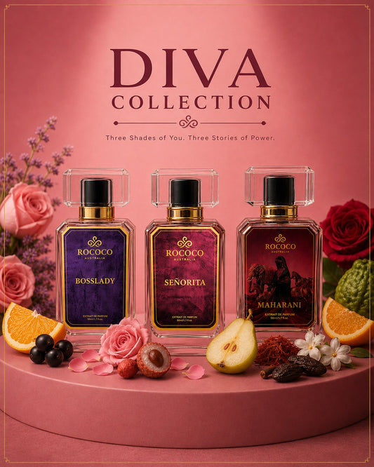 Three Rococo perfume bottles from the Diva Collection are displayed on a pink pedestal with decorative flowers, fruit, and botanical elements. The bottles feature purple and deep red labels with gold accents, set against a solid pink background with the text 'DIVA COLLECTION' at the top.